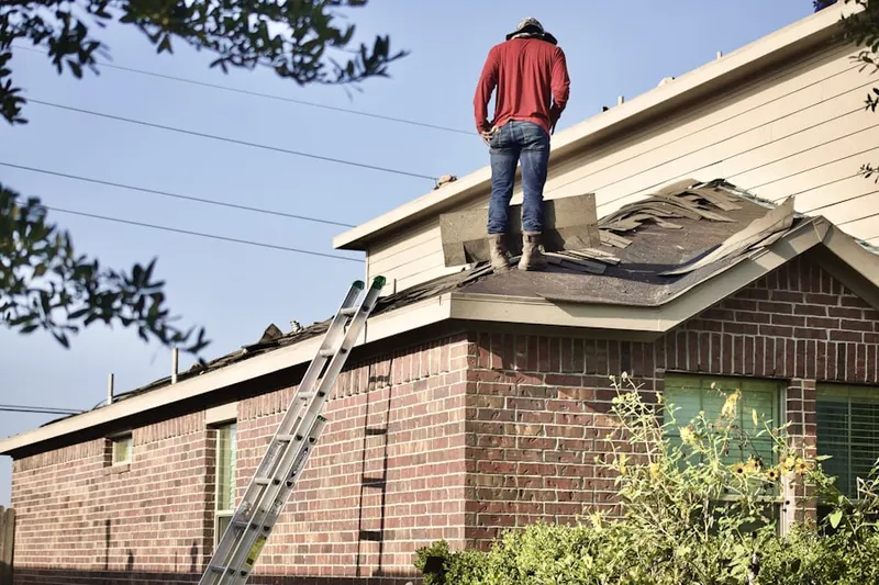 Professional roofer working on a residential roof in Stonewood